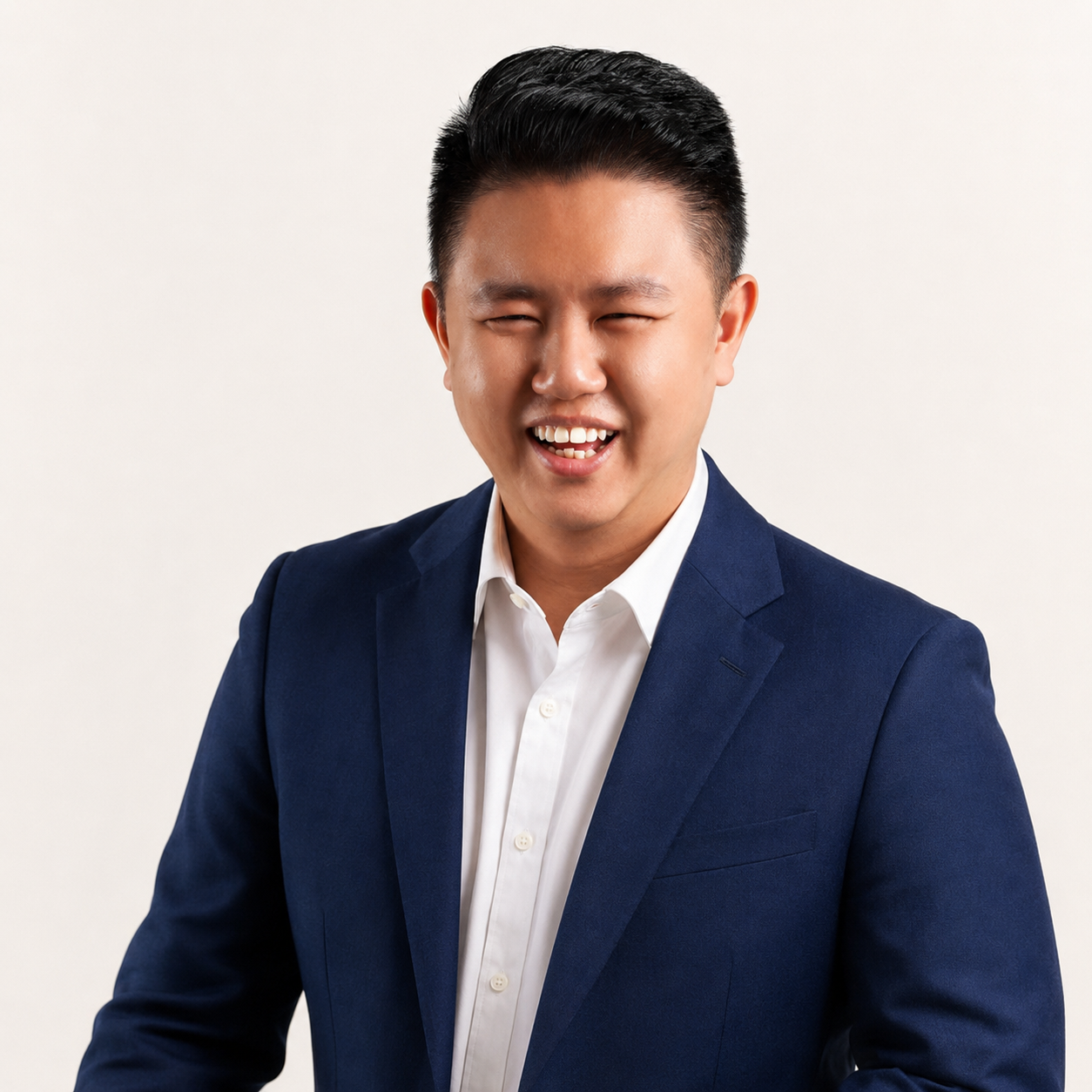 Kyl Liew smiling, wearing a navy jacket
